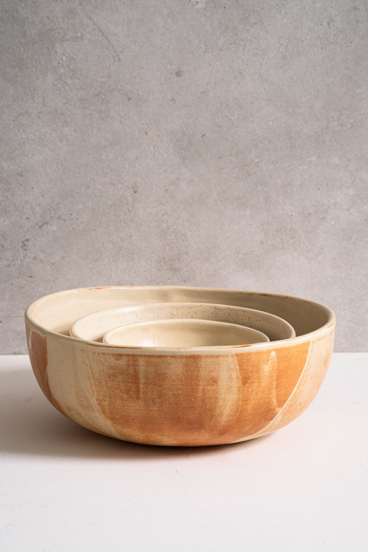 Beige matte stoneware salad serving bowl with reactive glaze and rust color strokes handcrafted in Ukraine