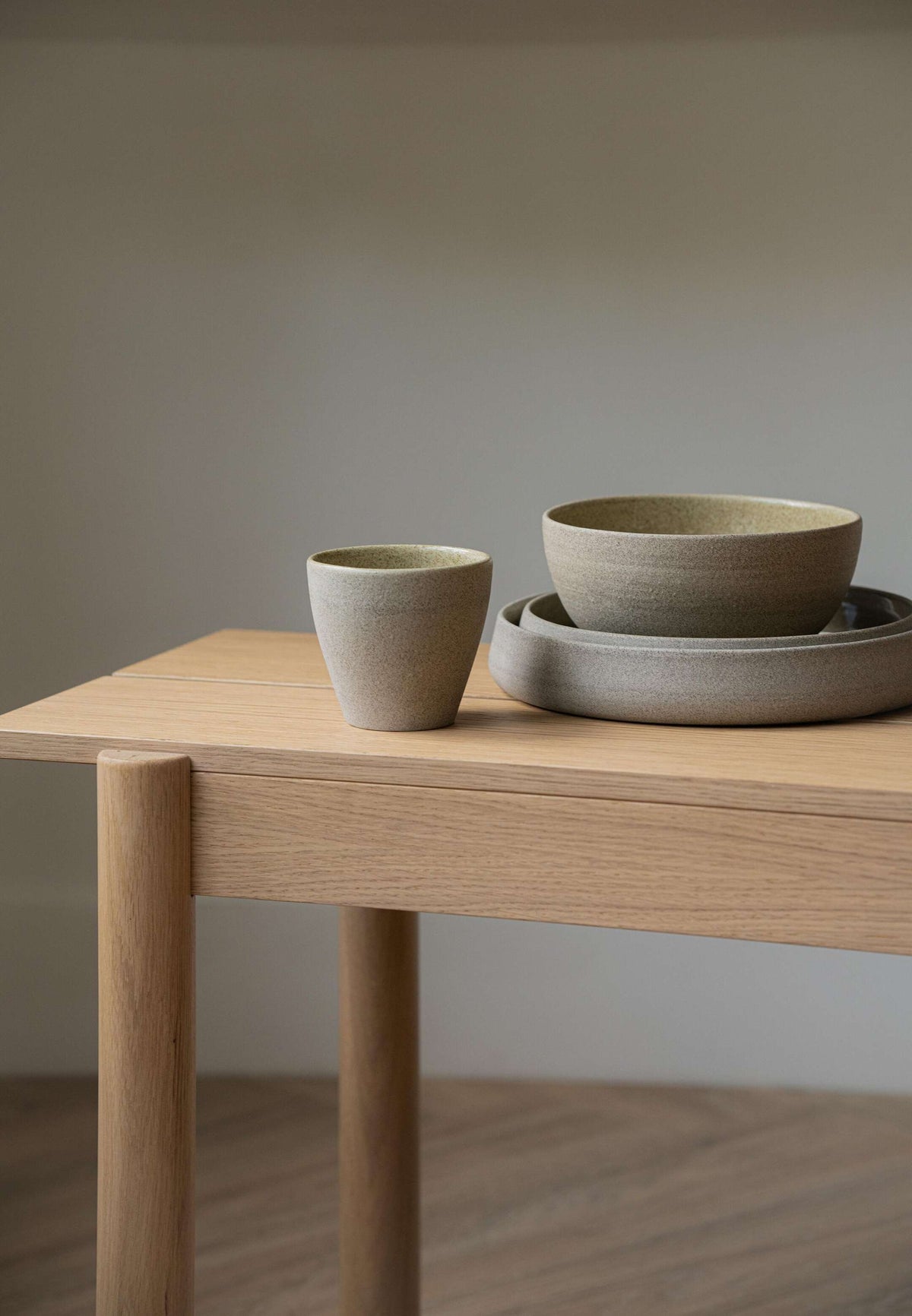 Handmade stoneware coffee mug with concrete-like texture and glossy interior glaze
