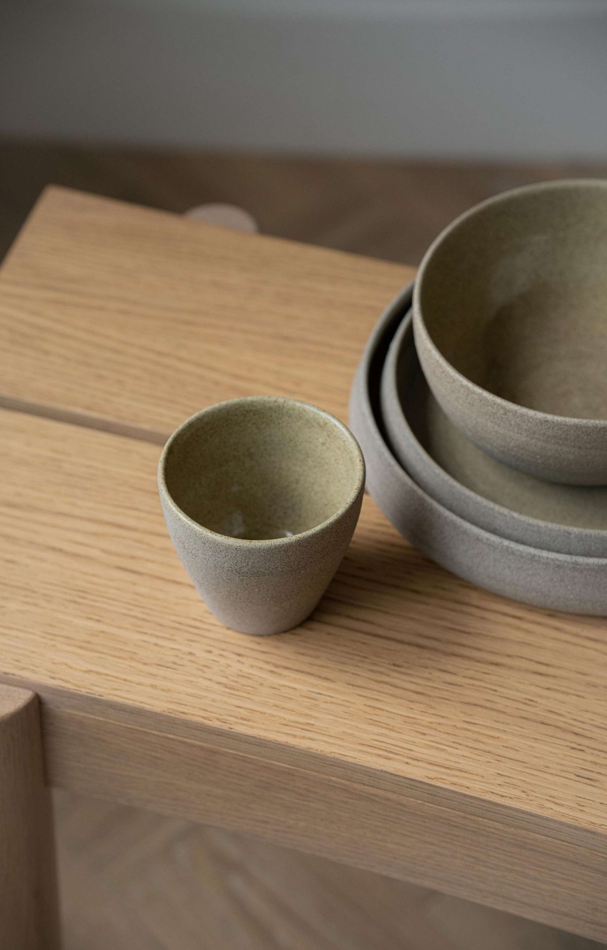Stoneware coffee mug with concrete-like texture, polished exterior, and glossy interior glaze
