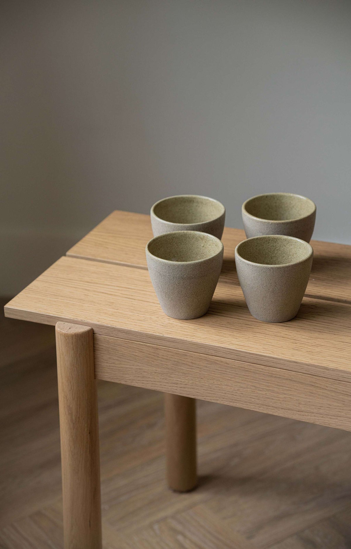 Handmade stoneware coffee mug with concrete-like texture and glossy interior glaze