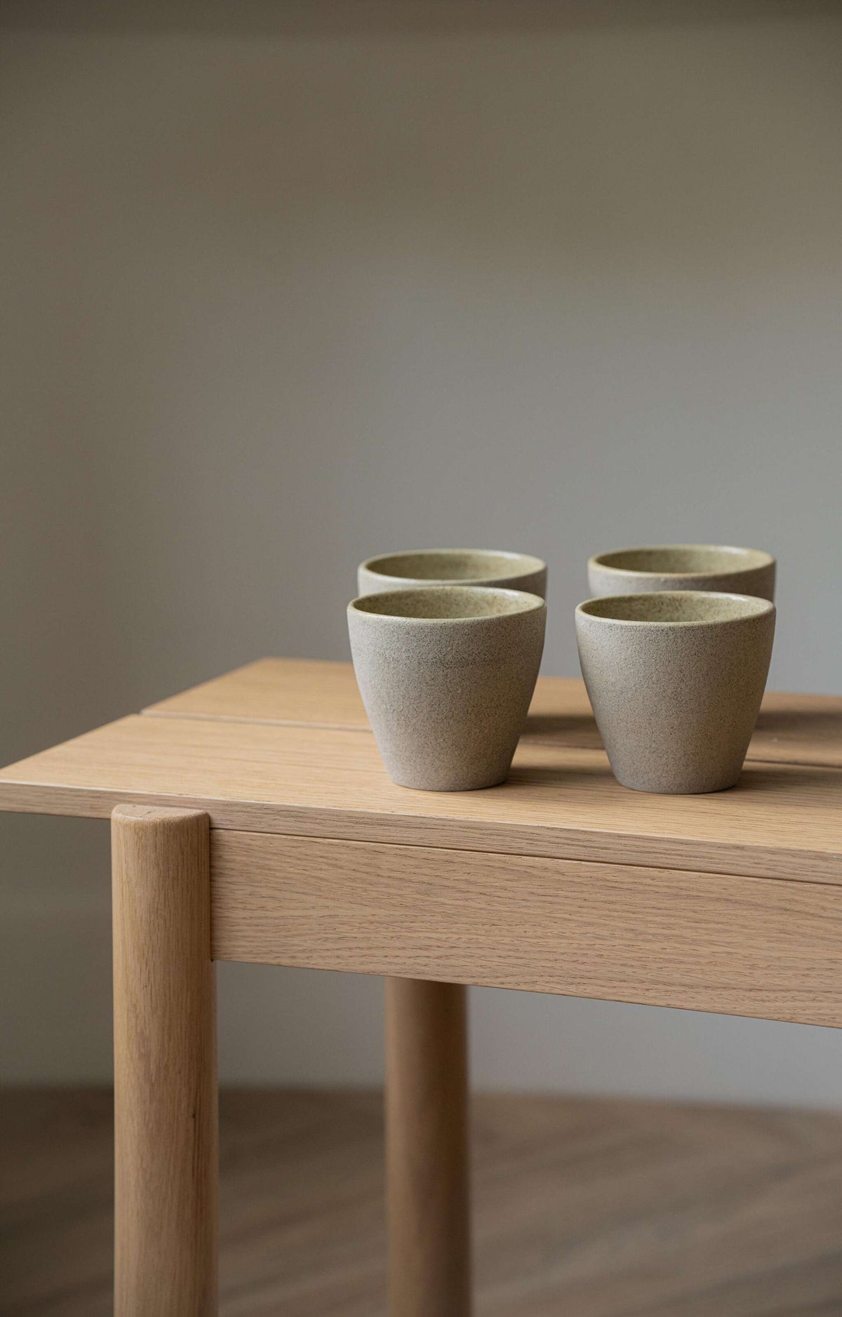 Handmade stoneware coffee mug with concrete-like texture and glossy interior glaze