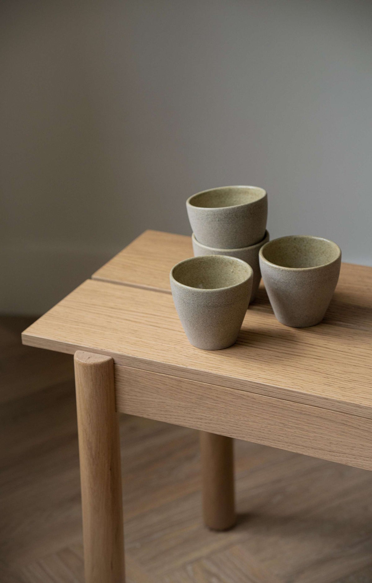Handmade stoneware coffee mug with concrete-like texture and glossy interior glaze