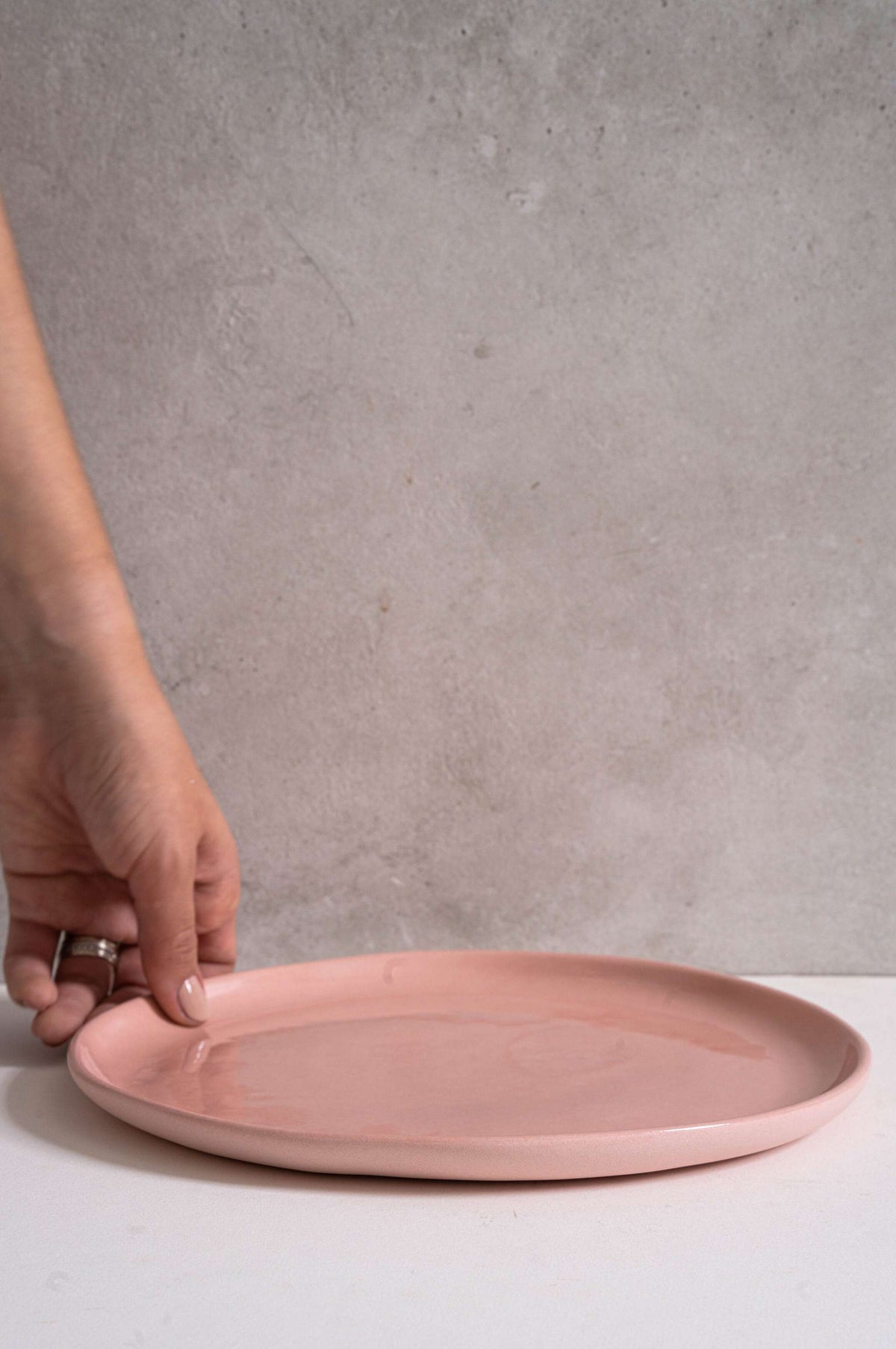 Set of powder pink handmade porcelain dinner plates with shiny glaze and smooth finish