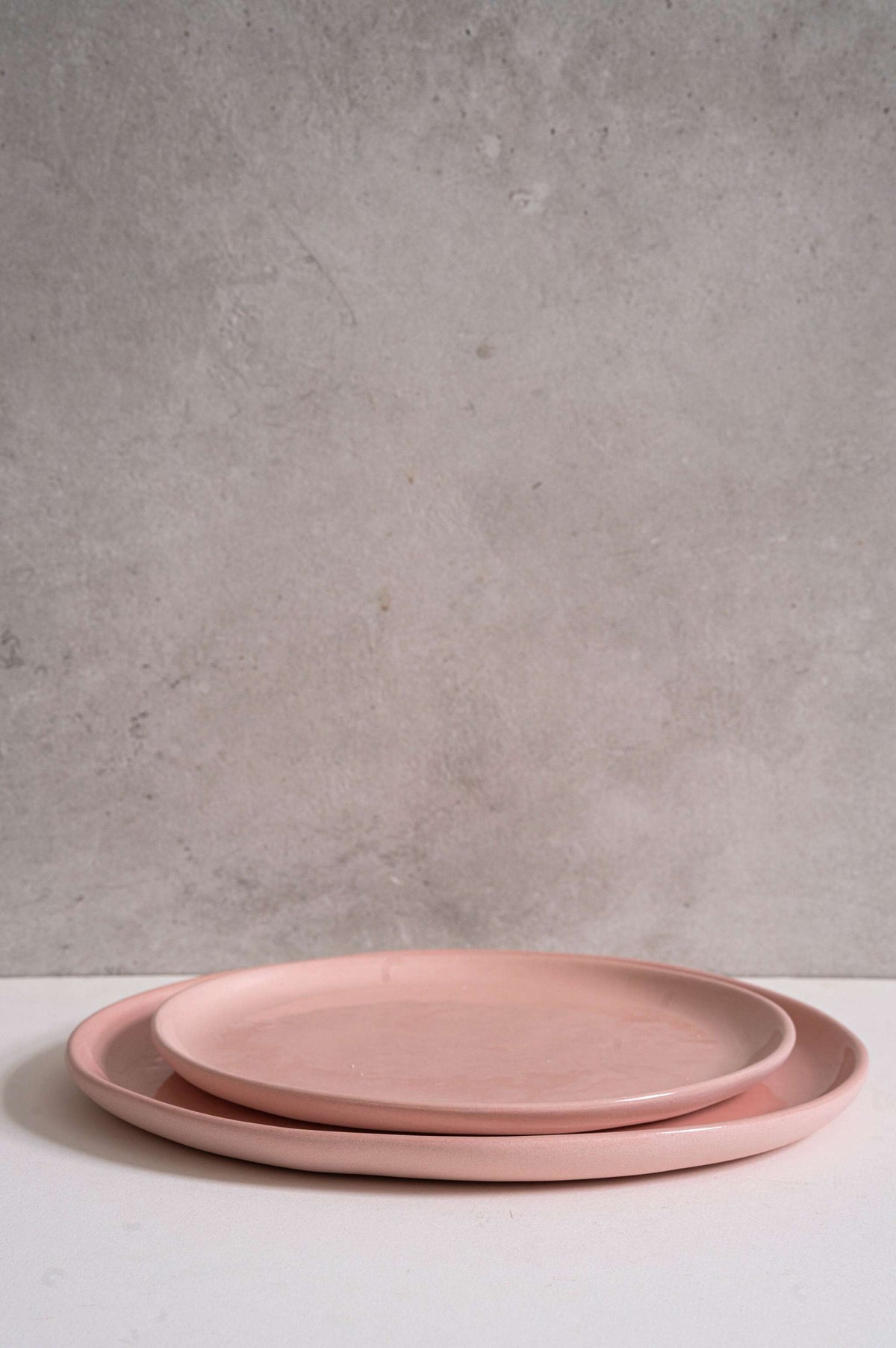 Powder pink handmade porcelain dinner plates set with shiny glaze, including dinner and salad plates, handmade in Ukraine