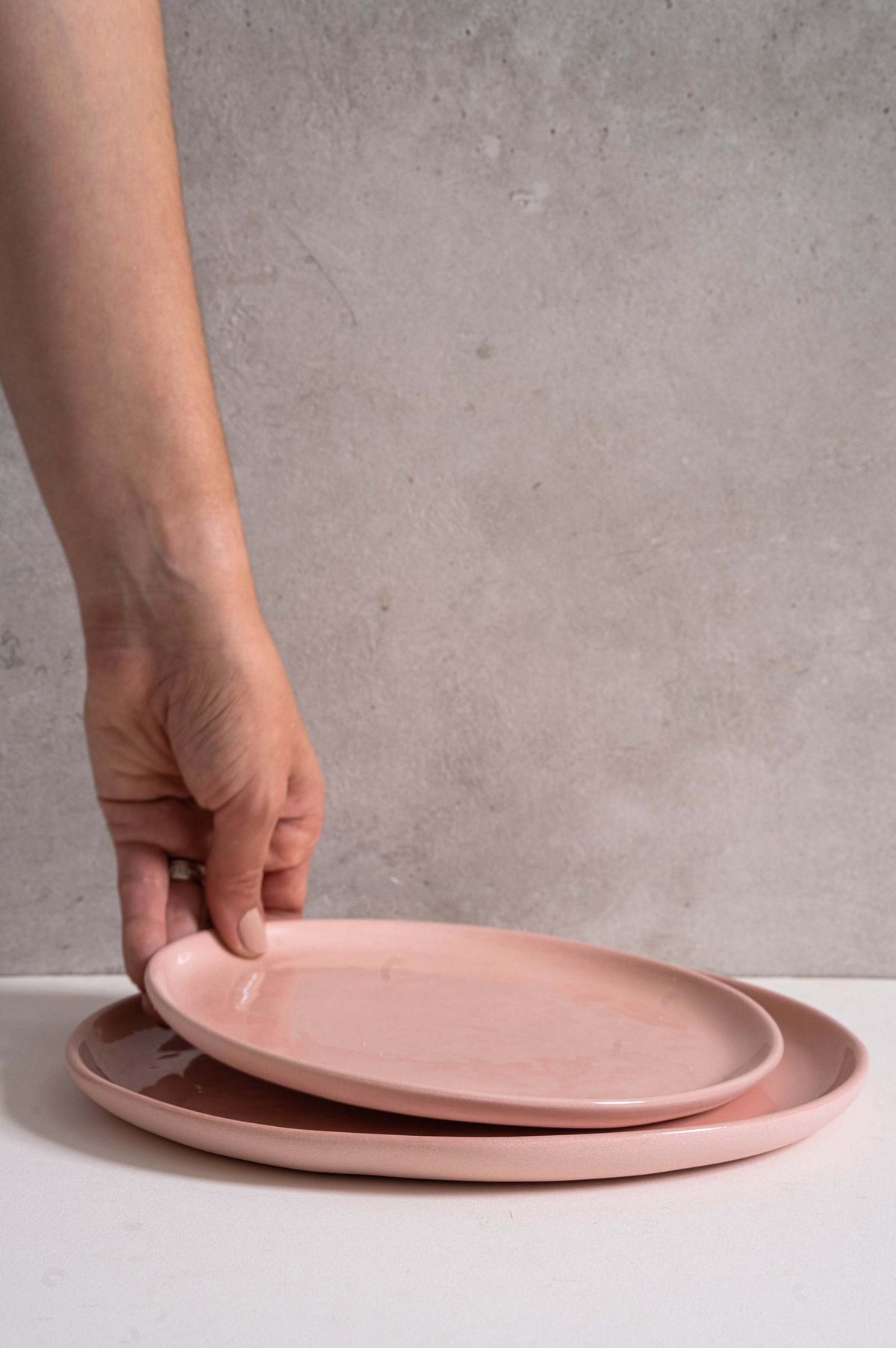 Handmade porcelain dinner plates set in powder pink with shiny glaze and smooth finish