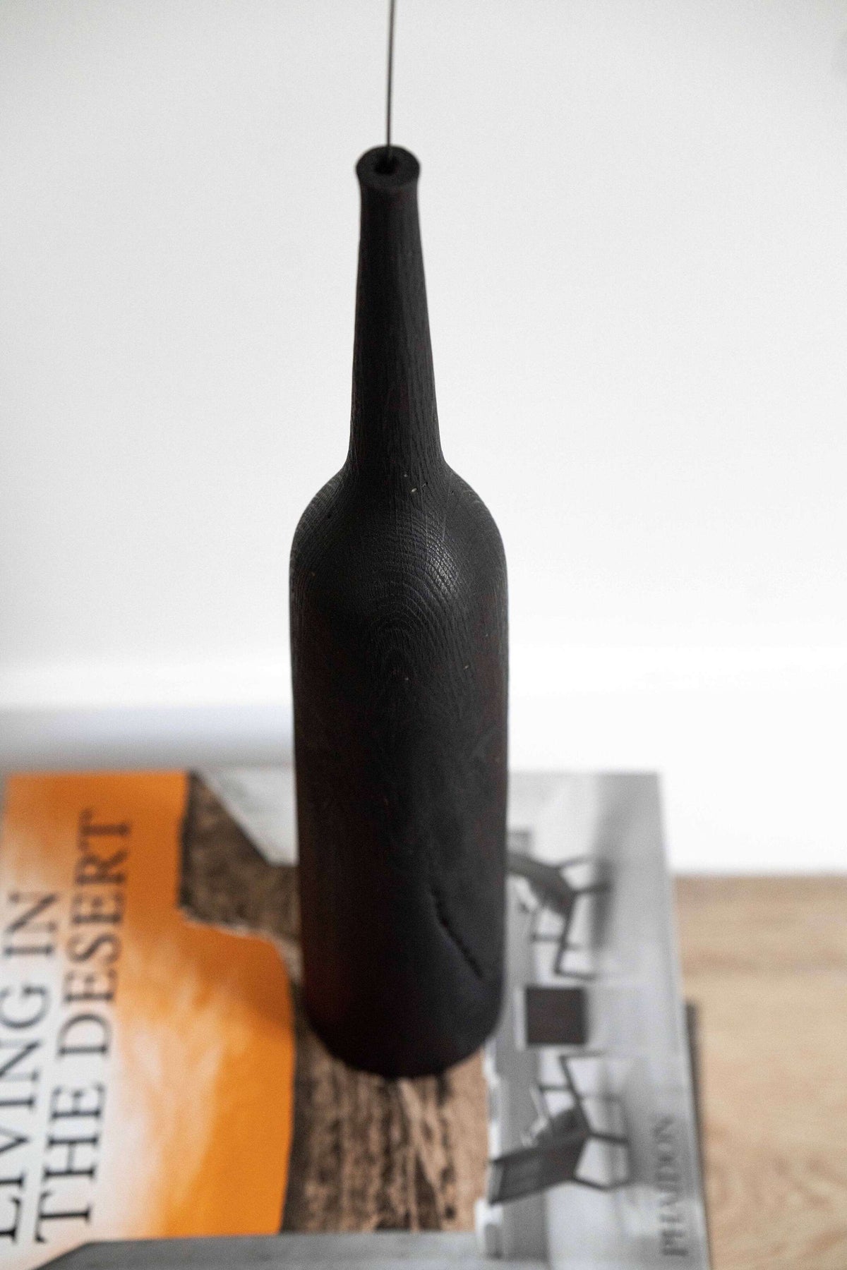 Tall charred oak wood vase with sharp shoulders and long neck, handcrafted in Ukraine
