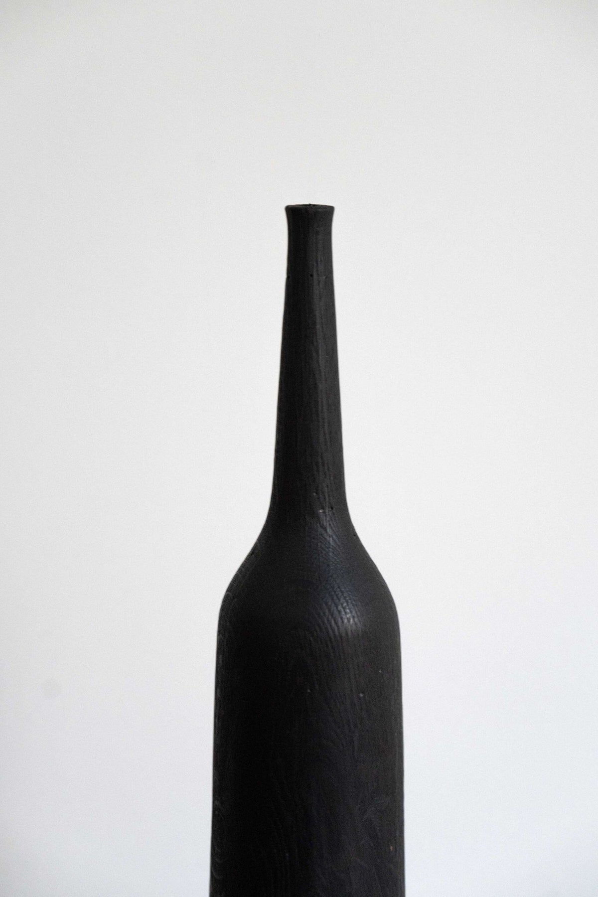 Tall charred oak wood vase with sharp shoulders and long neck, handcrafted in Ukraine