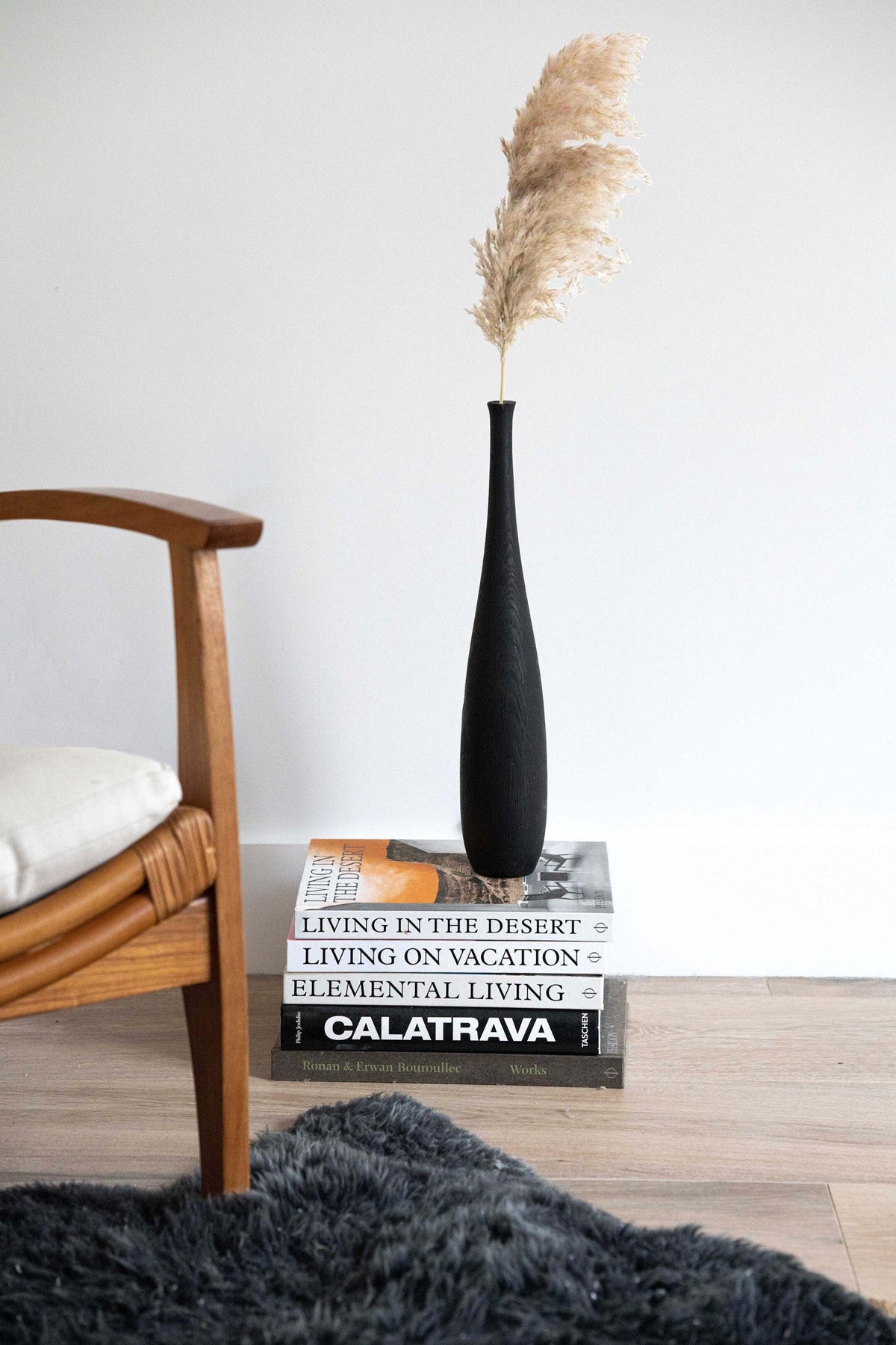Tall charred oak wood vase with sharp shoulders and long neck, handcrafted with natural texture, 18-inch height.
