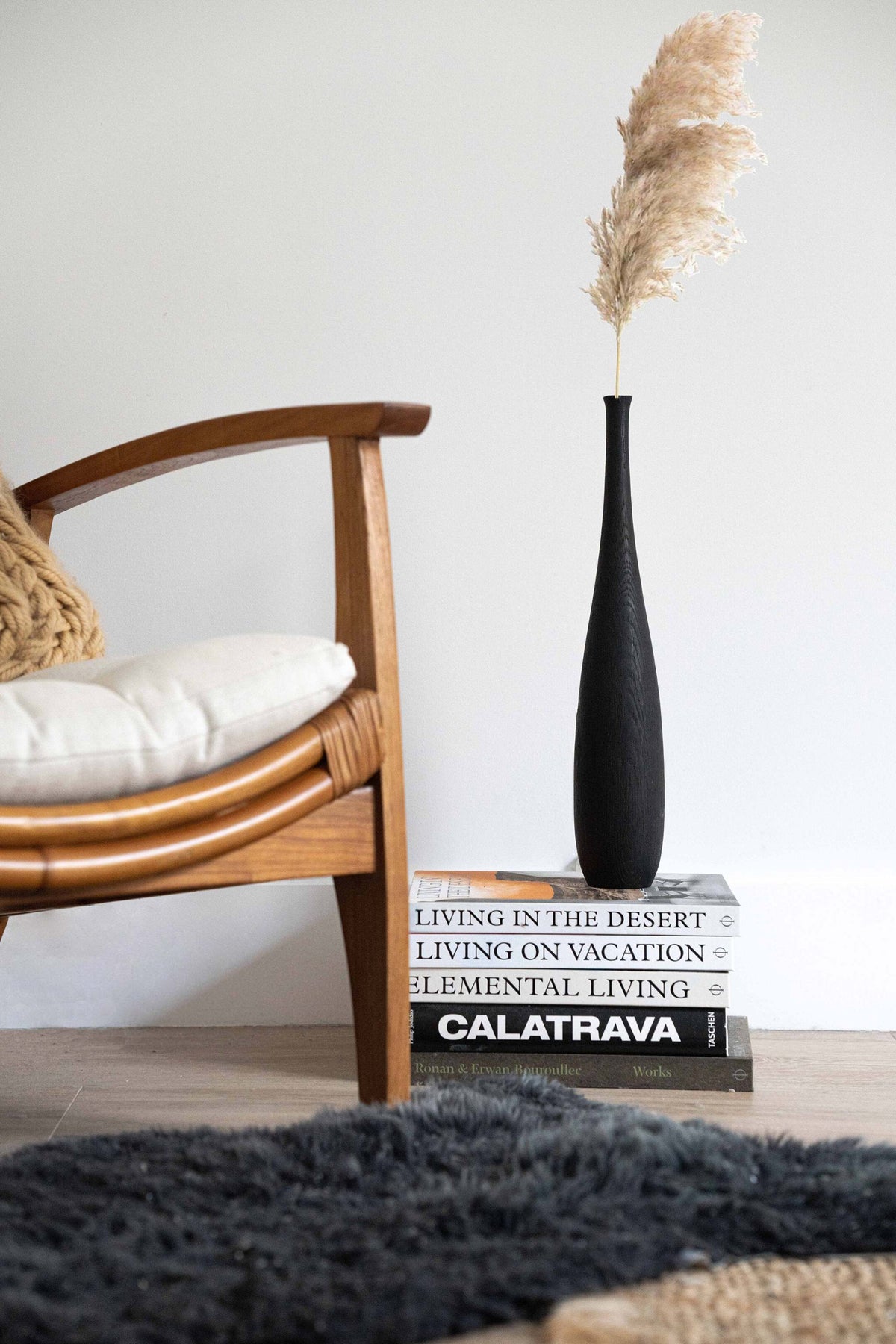 Tall charred oak wood vase with sharp shoulders and long neck, handcrafted with natural texture.