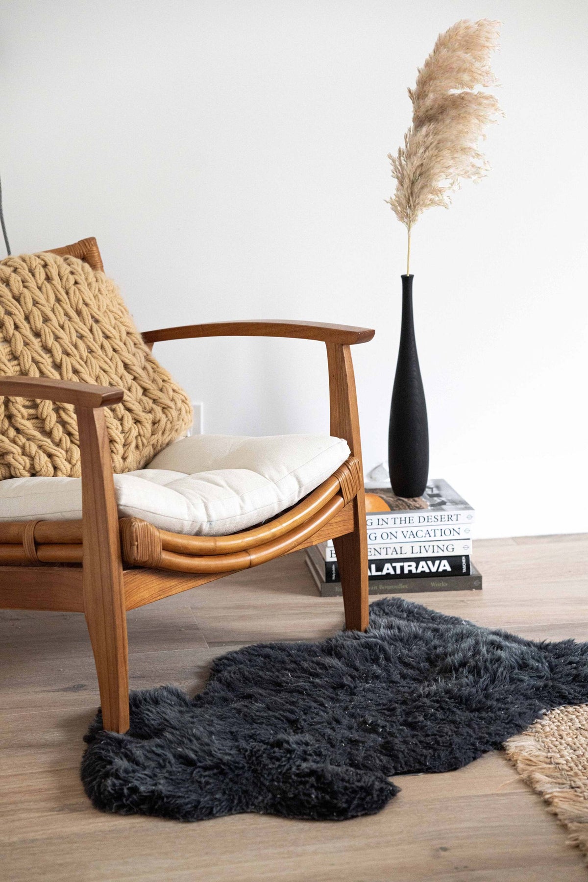 Tall charred wood vase with sharp shoulders and long neck, handcarved from oak showing natural texture and rustic modern design.