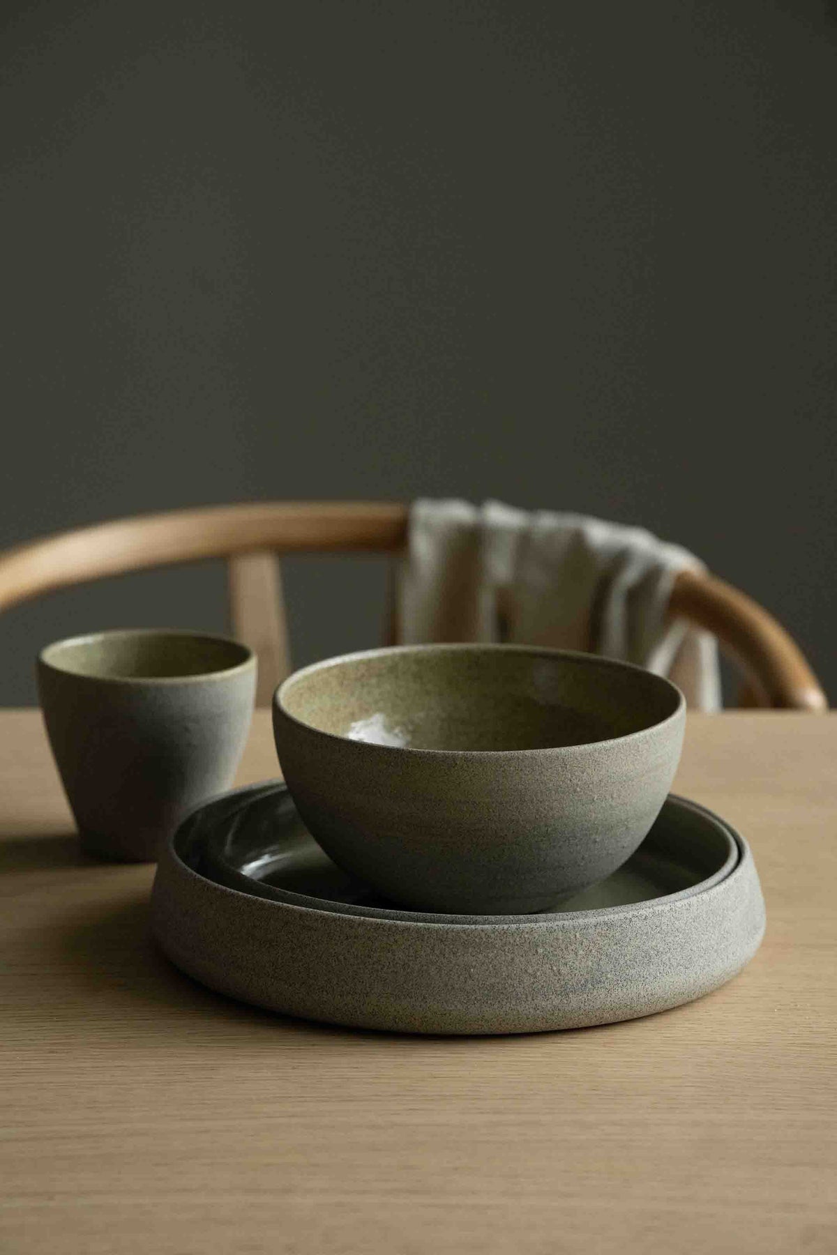 Handmade stoneware dinner set with matte exterior and glossy interior including plate, bowl, and coffee cup from Concrete Collection