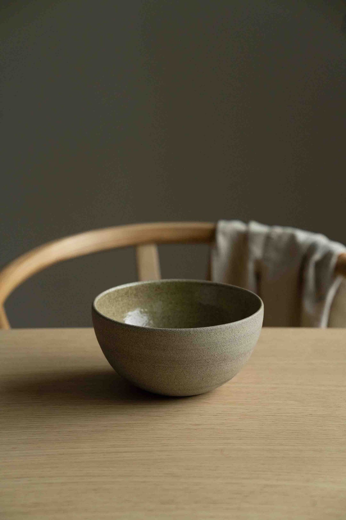 Handmade stoneware dinner set with matte stone-like exterior and glossy interior including plate, bowl, and coffee cup