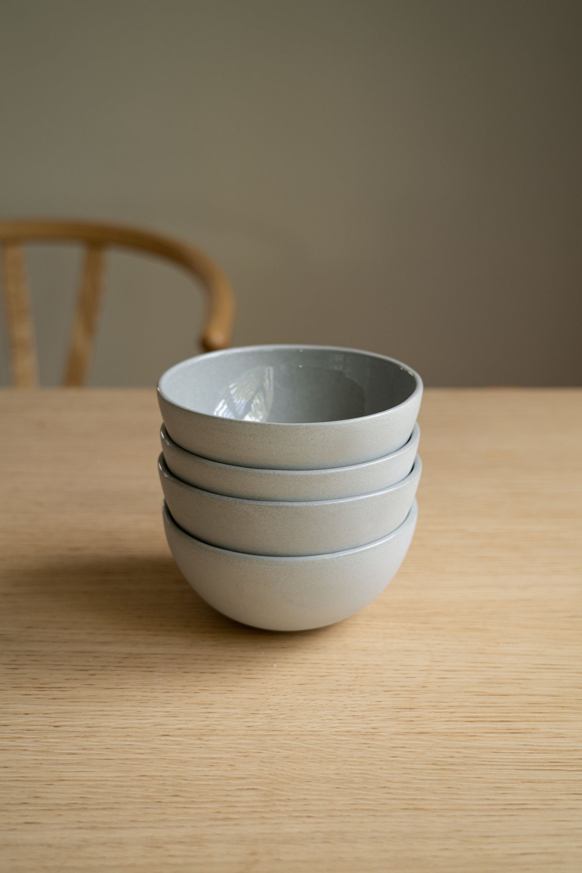 Handmade porcelain bowl in gray sky color with shiny glaze and smooth polish