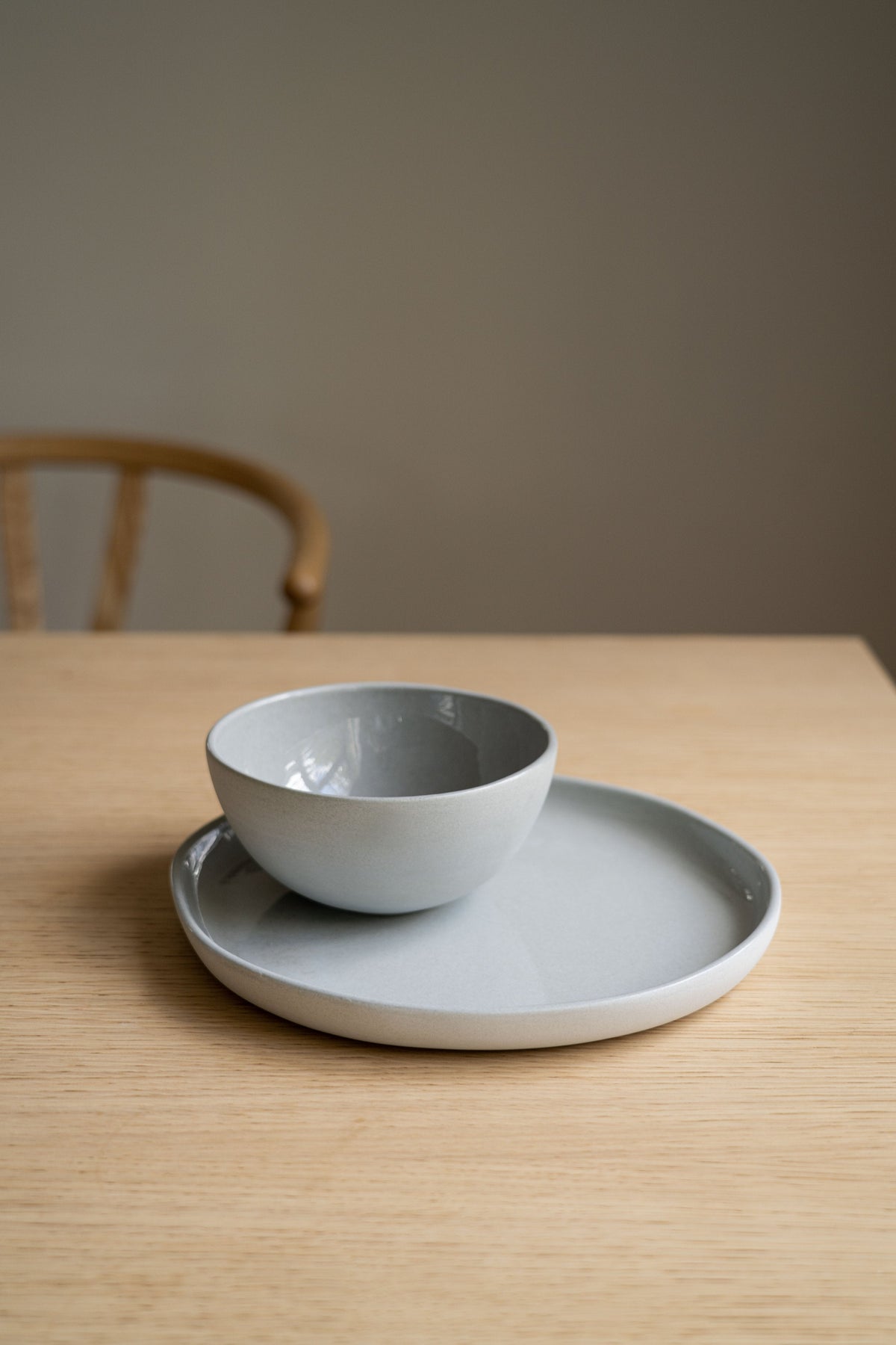 Handmade porcelain bowl in gray sky color with shiny glaze and smooth finish