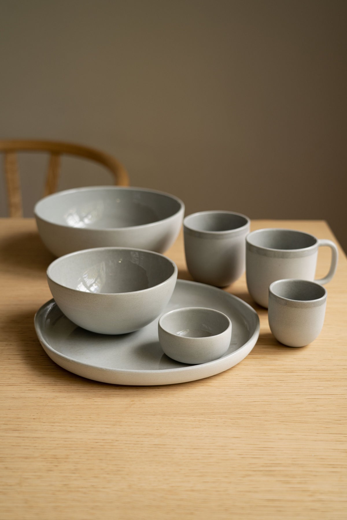 Handmade porcelain bowl in gray sky color with shiny glaze and smooth exterior, made in Ukraine