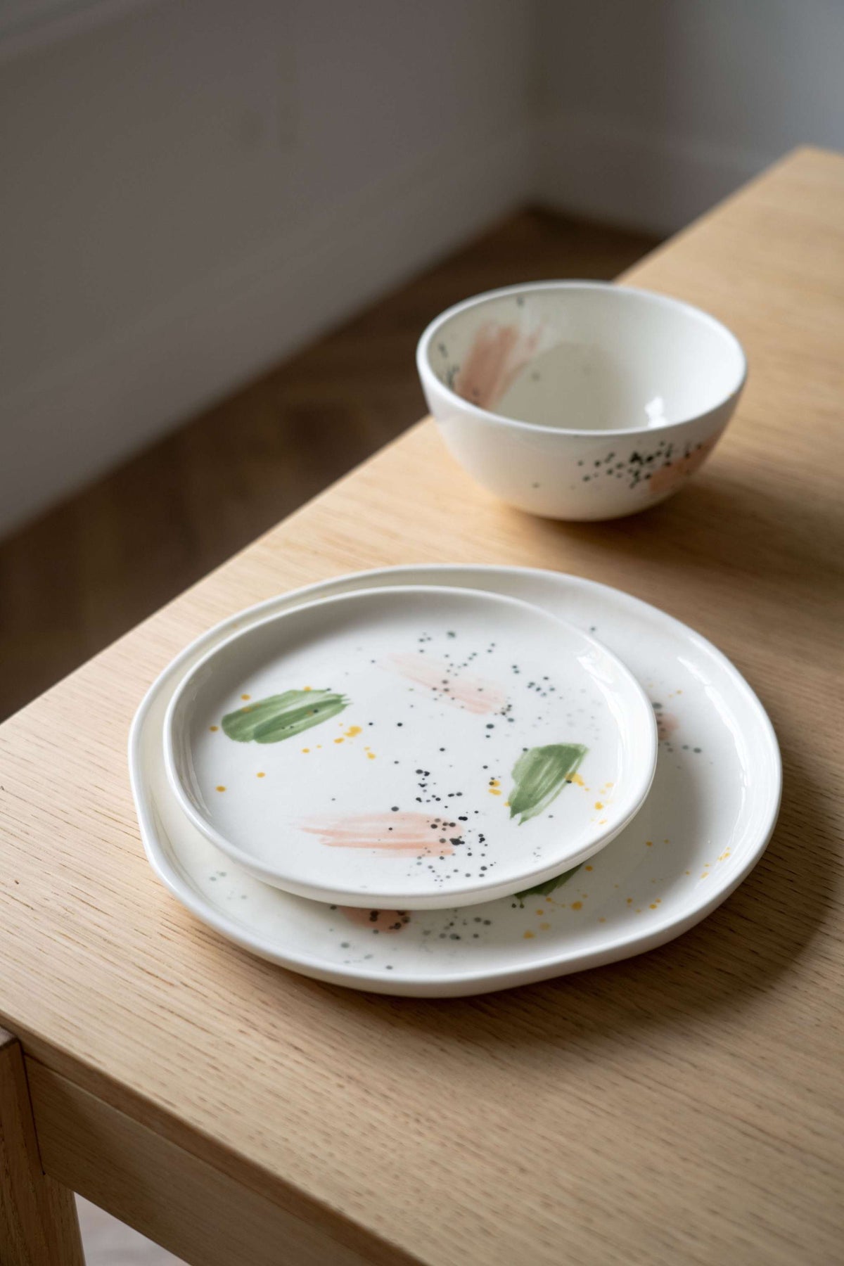 Off-white handmade porcelain dinner plate with hand-painted strokes, glazed and dishwasher-safe, made in Ukraine