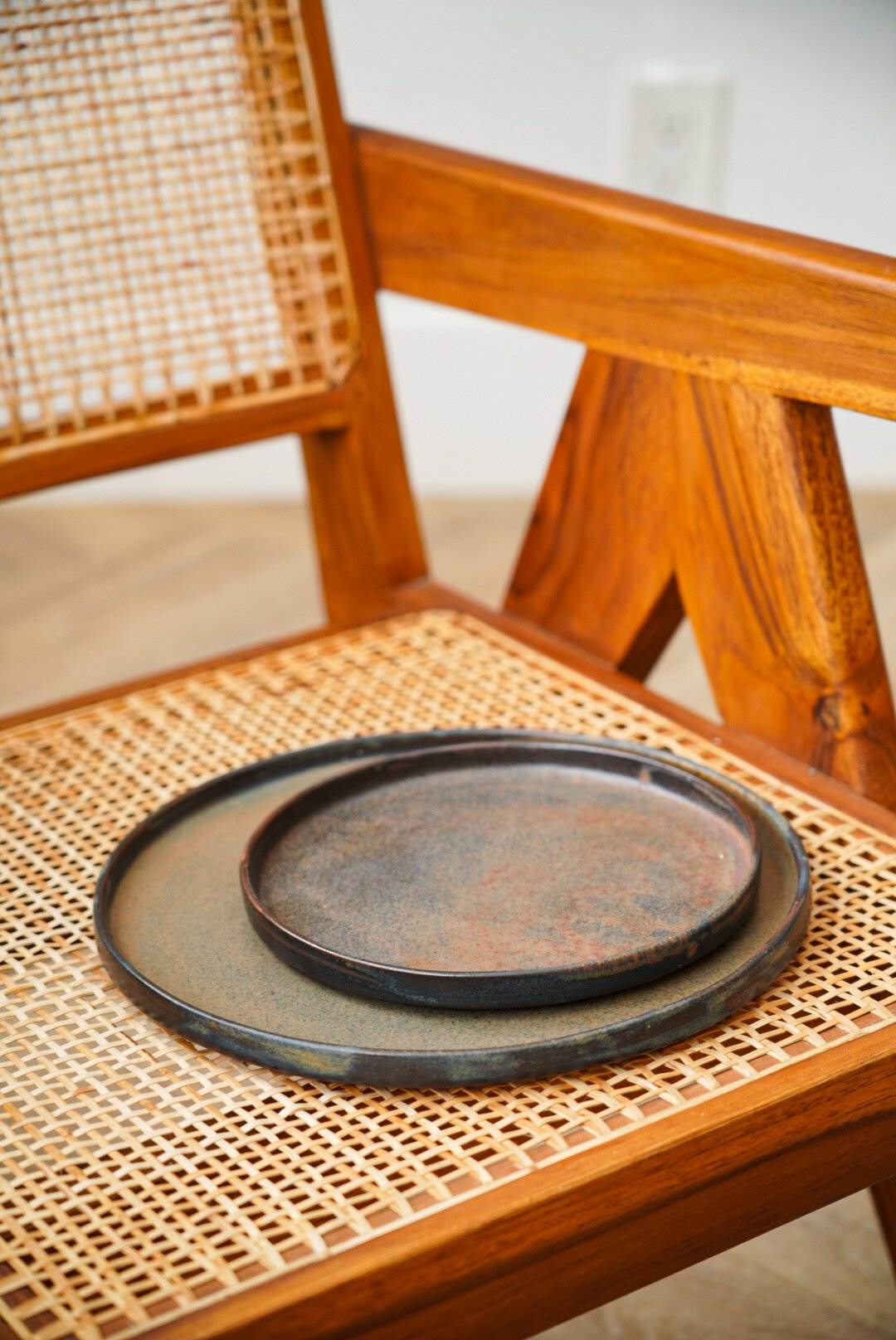 Matte brown-black rust stoneware dinner plate with reactive glaze swirl handcrafted in Ukraine