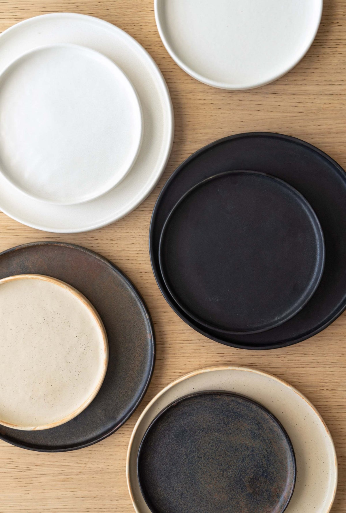 Matte brown-black rust stoneware dinner plate with unique reactive glaze swirl, handmade in Ukraine