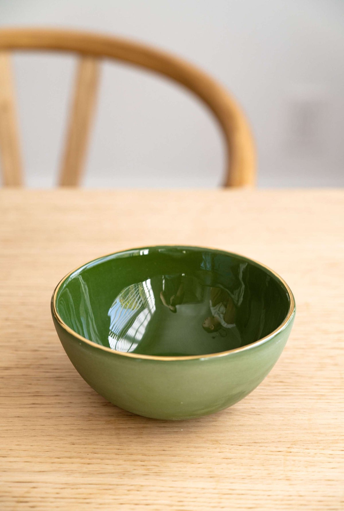 Handmade green porcelain bowl with gold rim and glossy food-safe glaze