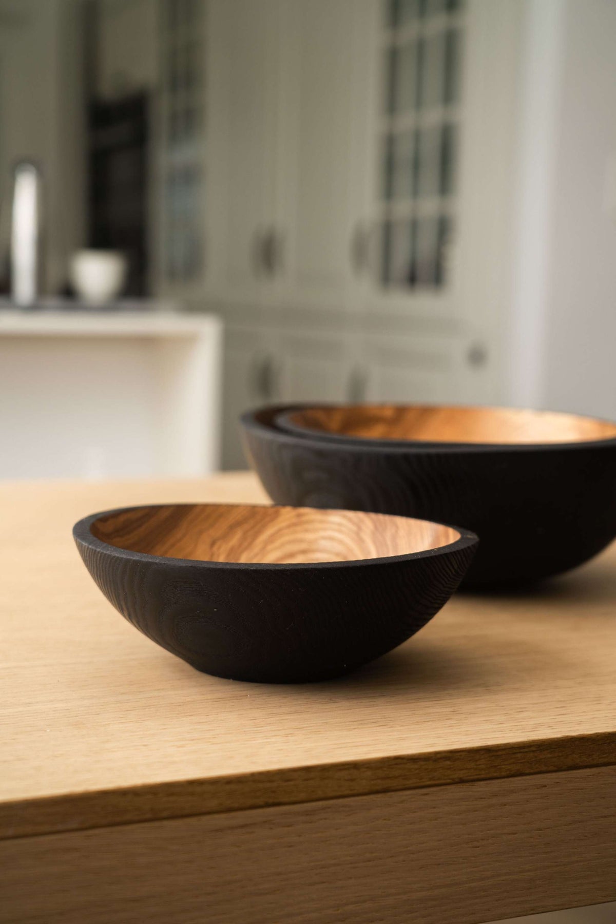 Nesting Bowl Set of dark charred wood bowls with warm natural grain interiors and smooth rounded shapes