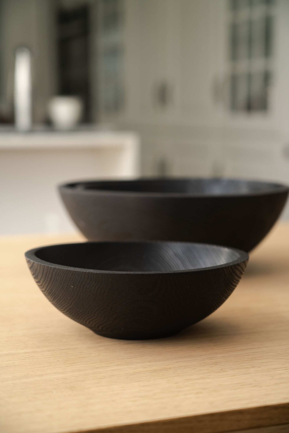 Hand Carved Charred Wooden Salad Bowl Set with two black wood bowls, featuring smooth interiors and carved textured exteriors.