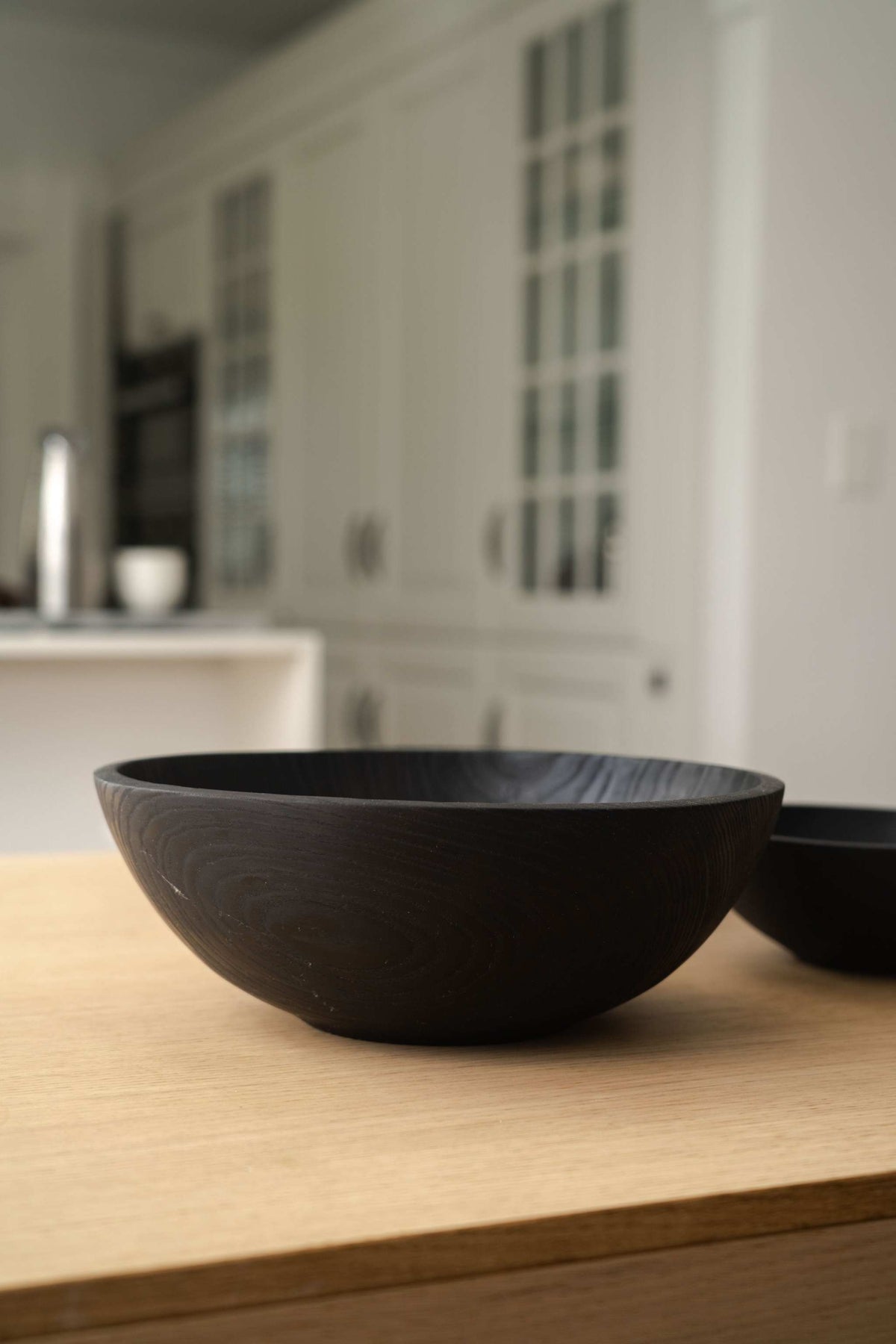 Hand Carved Charred Wooden Salad Bowl Set with a smooth, deep black finish and rounded, hand-carved wooden bowl forms.