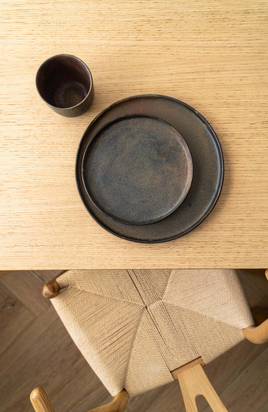 Matte rust stoneware dinner plate with unique reactive glaze and low rim, handmade in Ukraine