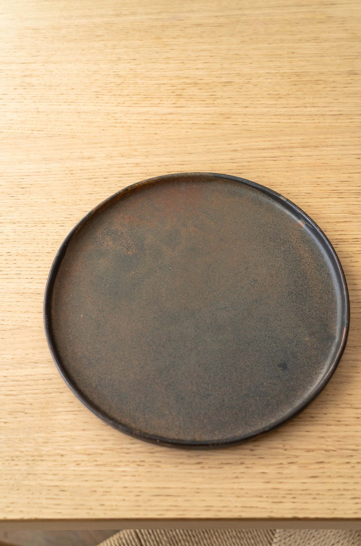 Matte brown-black rust dinner plates with unique reactive glaze swirl, handmade stoneware from Ukraine