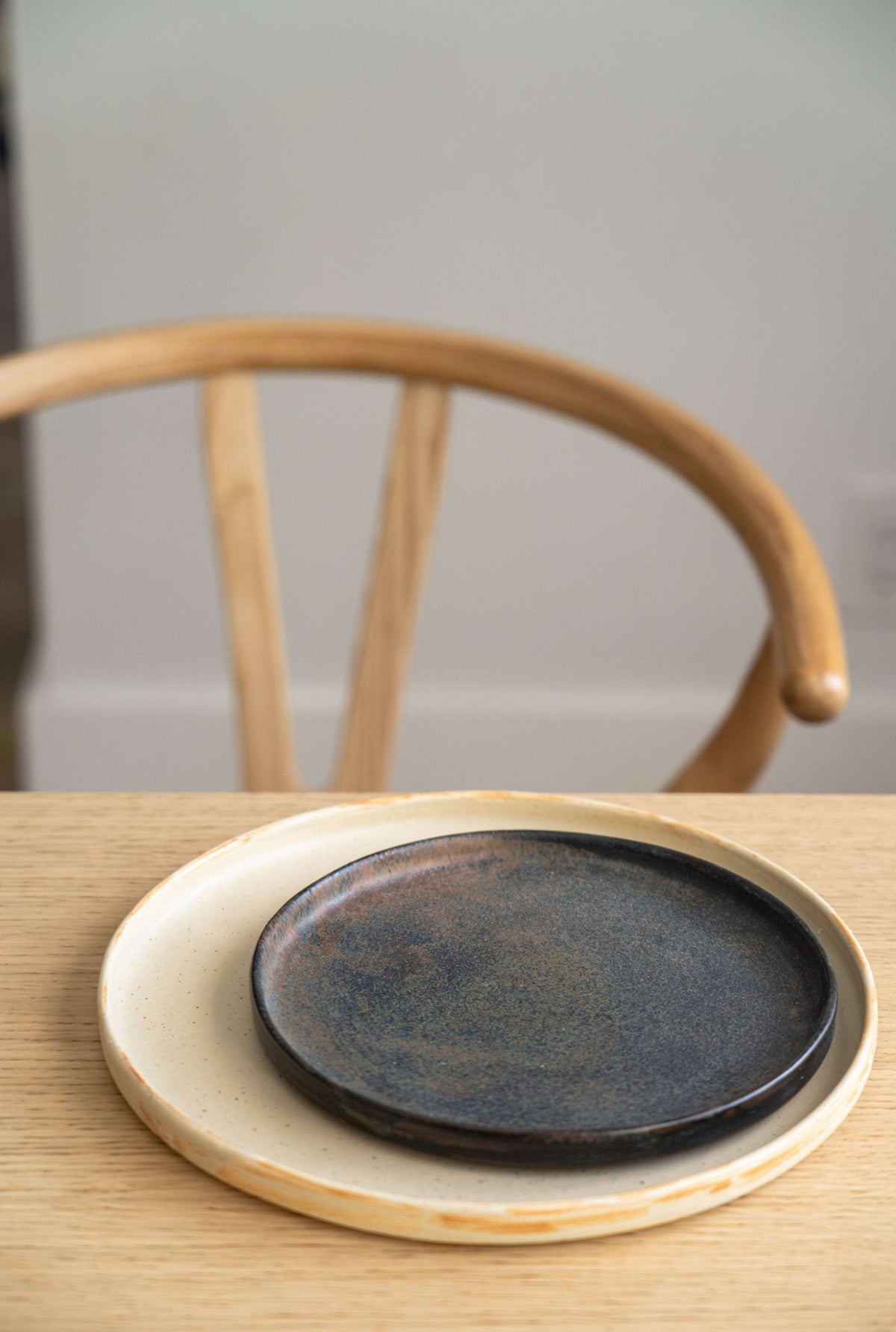 Beige matte stoneware dinner plates with unique reactive glaze and geometric design handcrafted in Ukraine