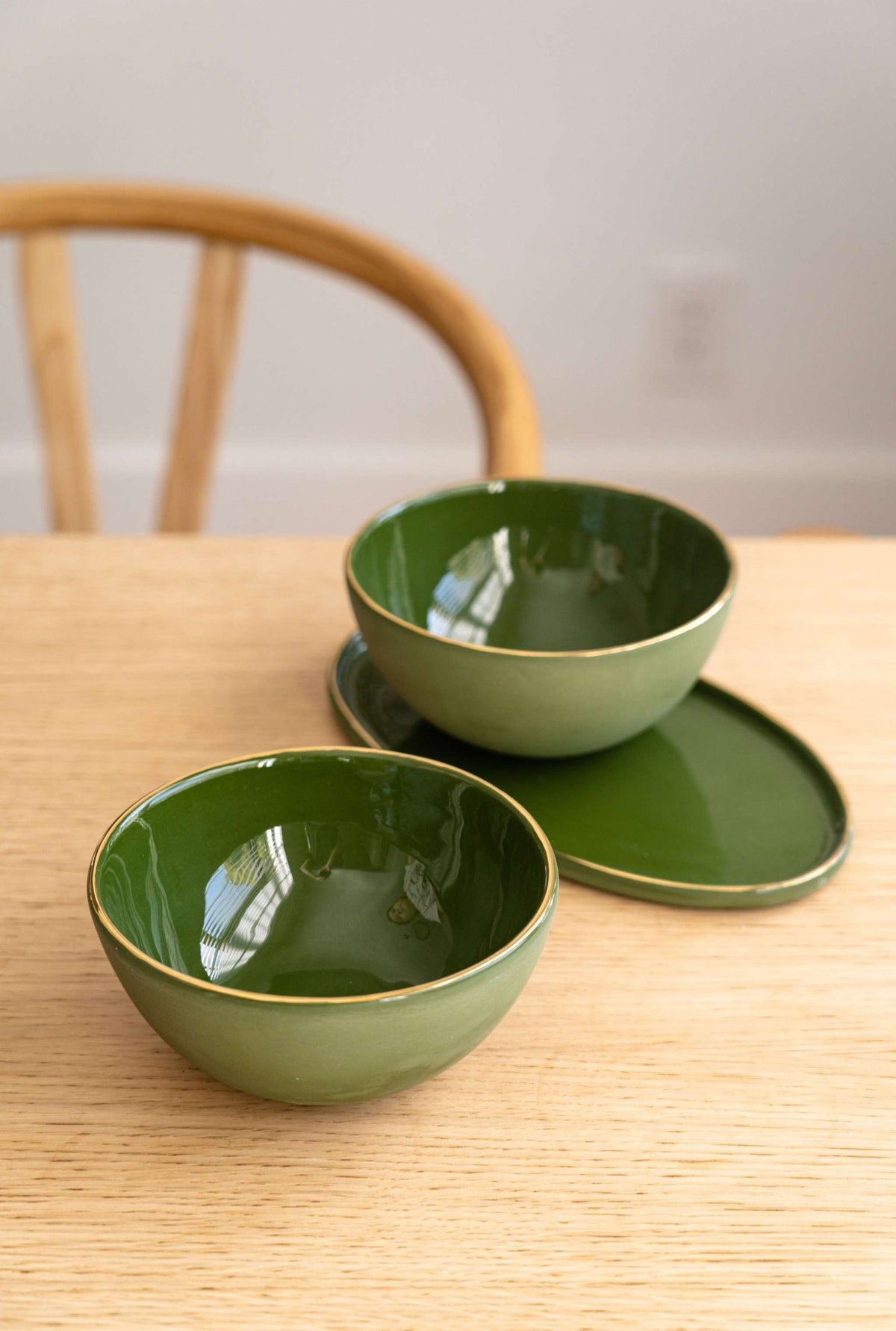Handmade green porcelain bowl with gold rim, elegant polished finish