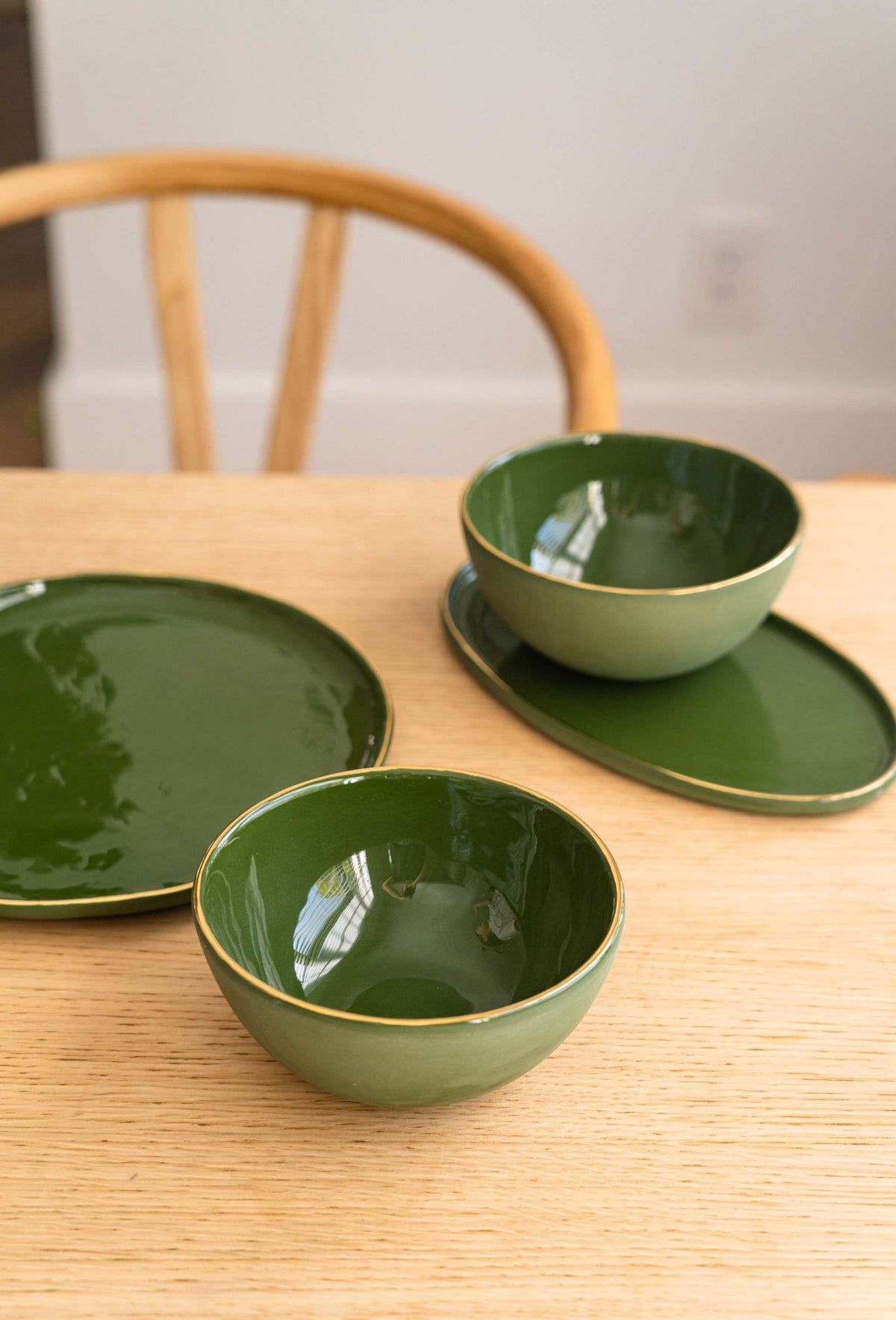 Handmade porcelain dinner plate with gold rim and green back, elegant and shiny finish