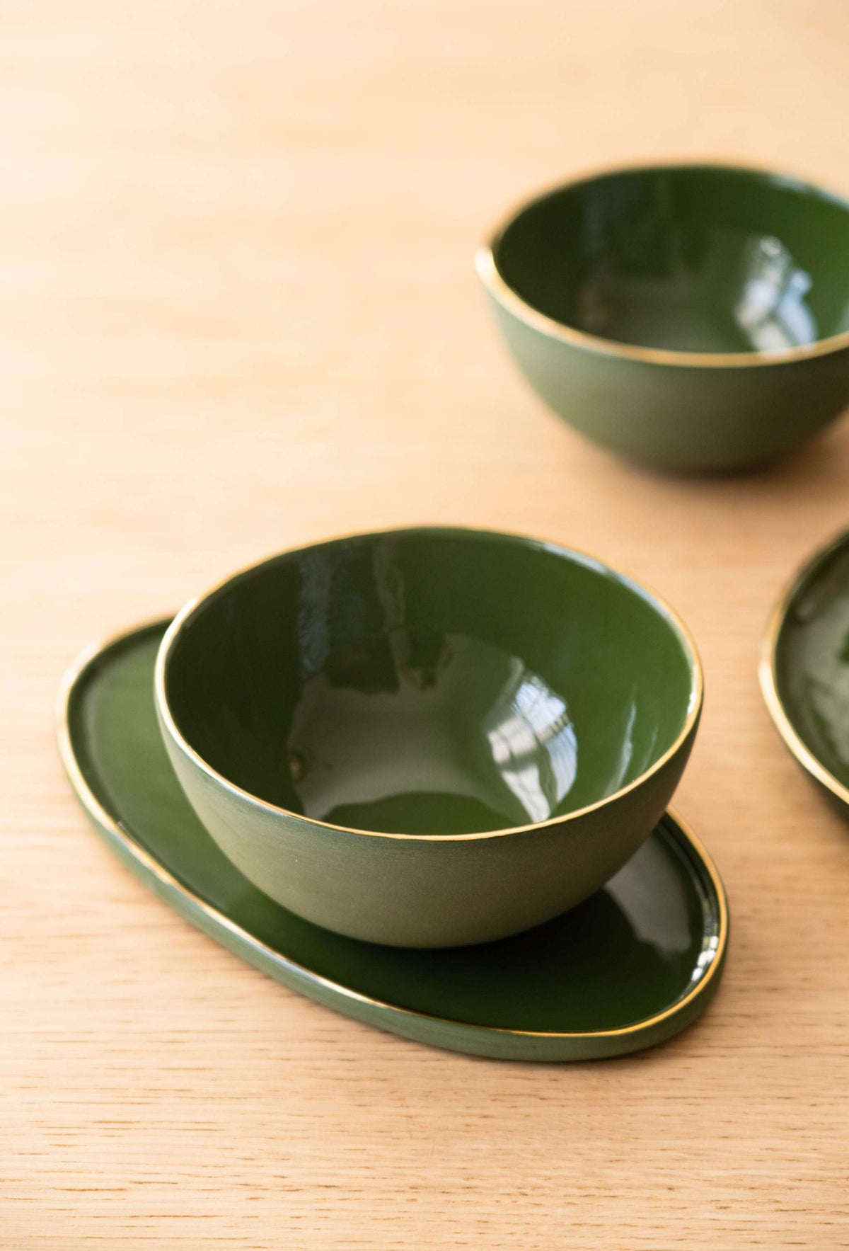 Handmade green porcelain oval serving platter with gold rim and organic edges
