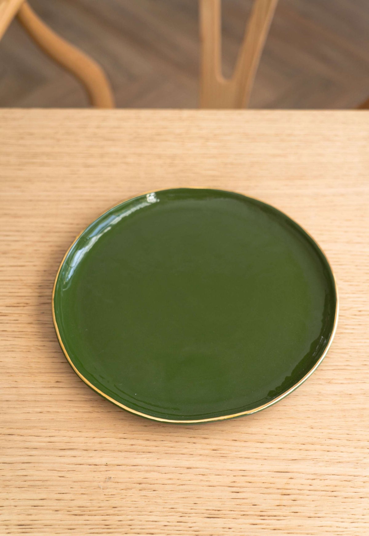 Handmade porcelain dinner plates with shiny glaze and gold rim in green color