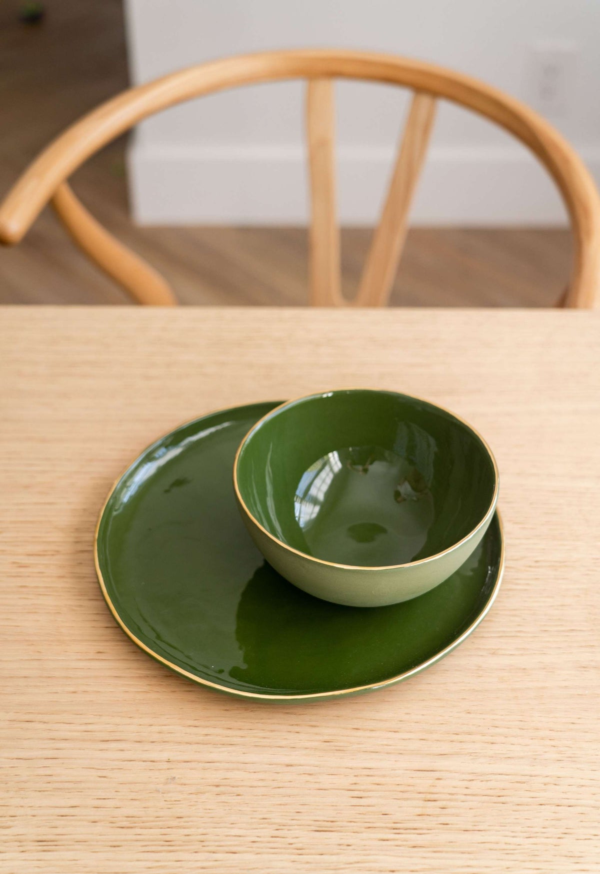 Handmade green porcelain bowl with gold rim, polished and food-safe glaze