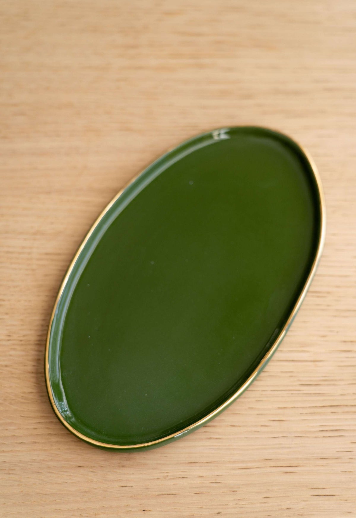 Handmade green porcelain oval serving platter with gold rim and organic edges
