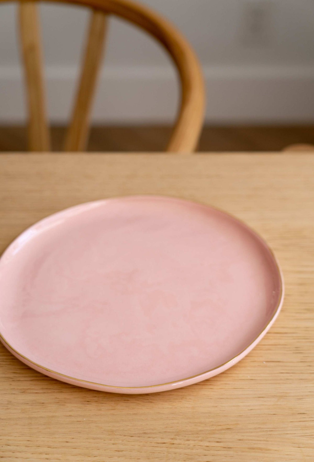 Handmade porcelain dinner plate in powder pink with gold rim and shiny glaze