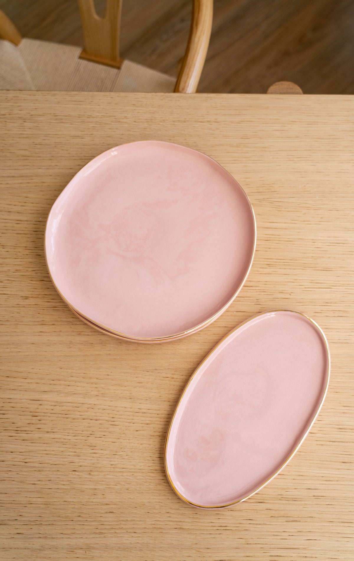 Handmade porcelain dinner plate in powder pink with gold rim and shiny neutral glaze