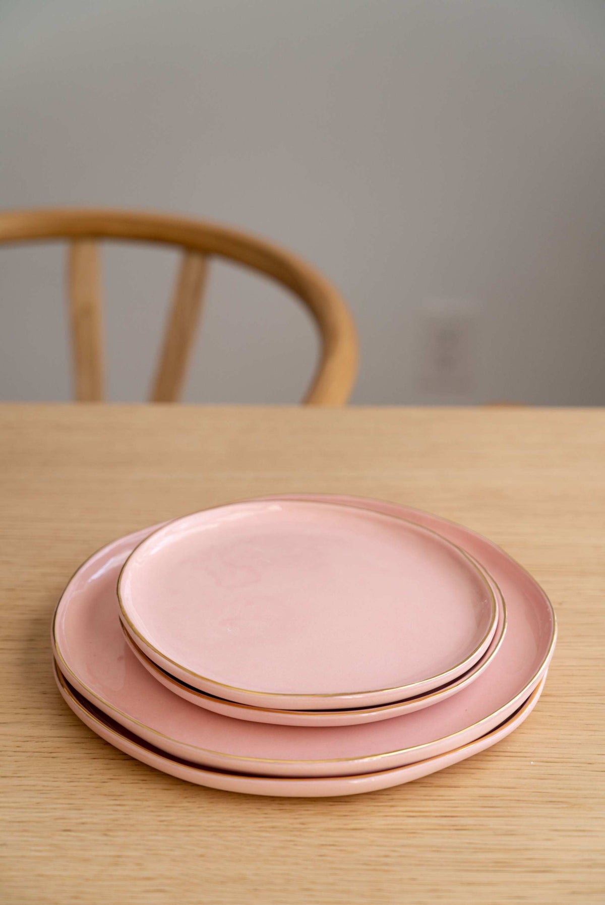 Handmade porcelain dinner plate in powder pink with gold rim and glossy finish