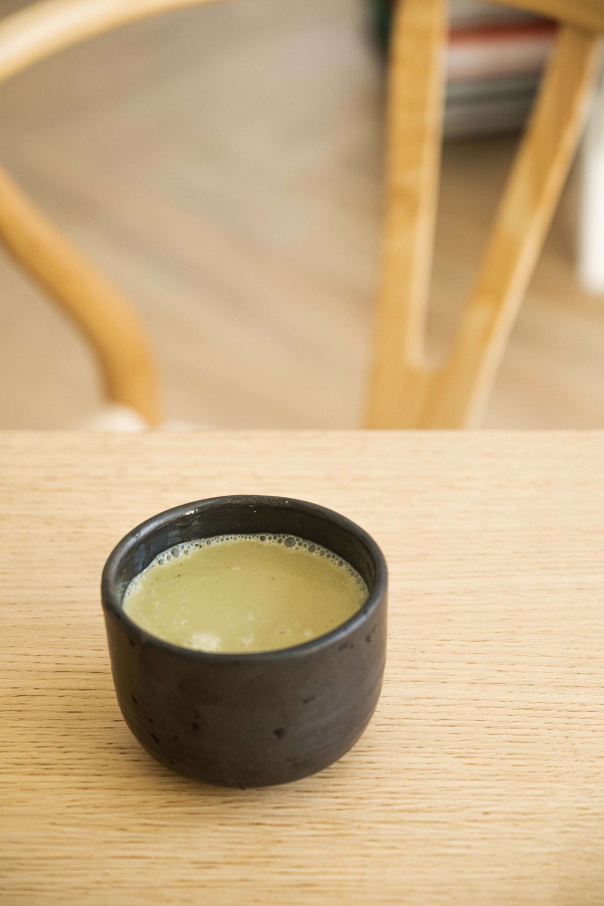 Minimalist handmade stoneware black matcha bowl with sharp vertical sides for whisking matcha tea