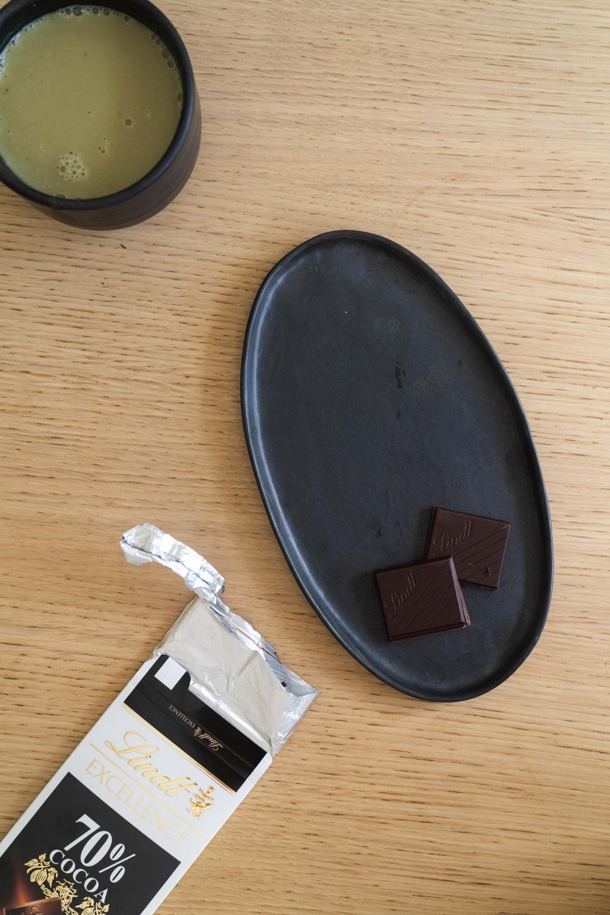 Black matte stoneware oval serving platter with organic edges and food-safe glaze, handmade in Ukraine