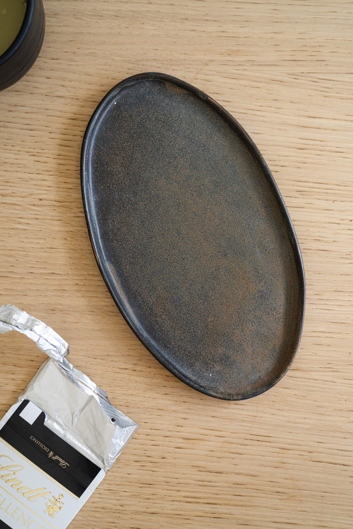 Rust matte handmade stoneware serving platter with organic edges and reactive glaze