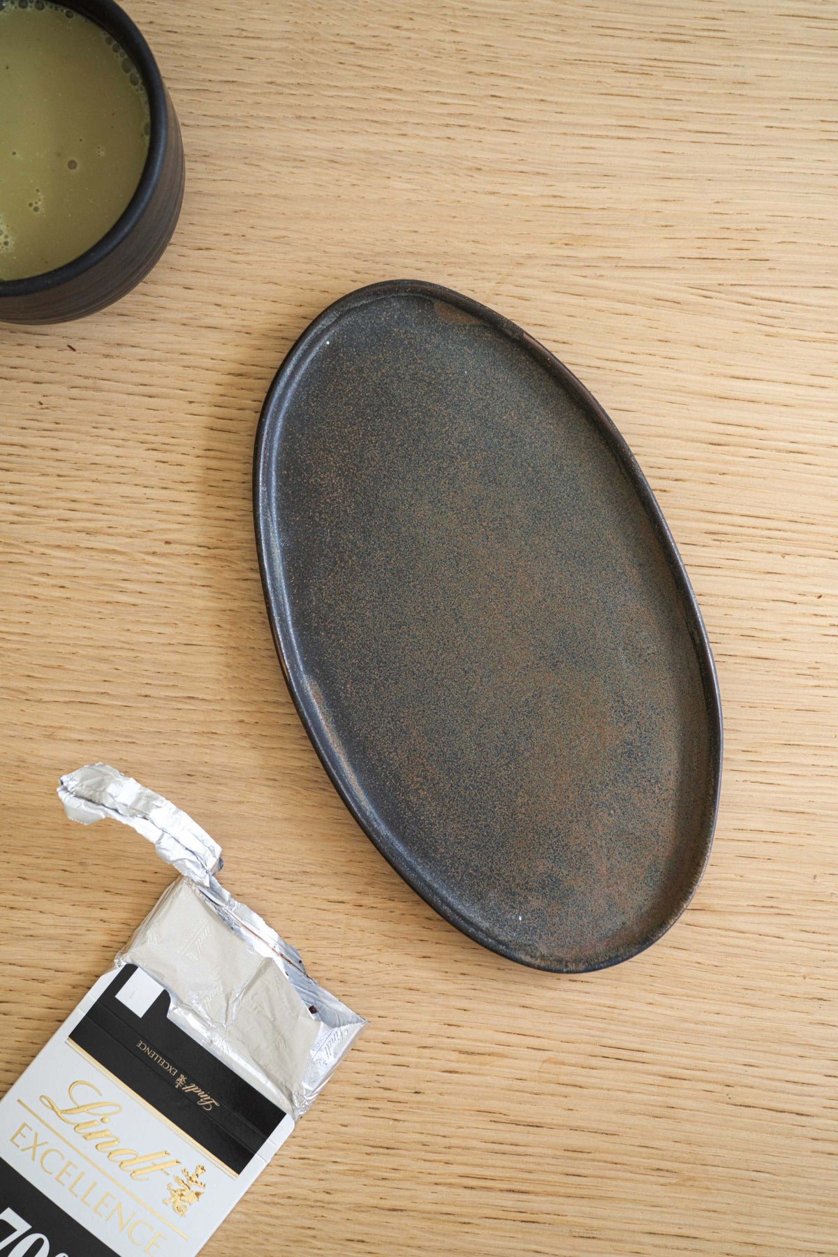 Rust matte oval stoneware serving platter with organic edges and reactive glaze handcrafted in Ukraine