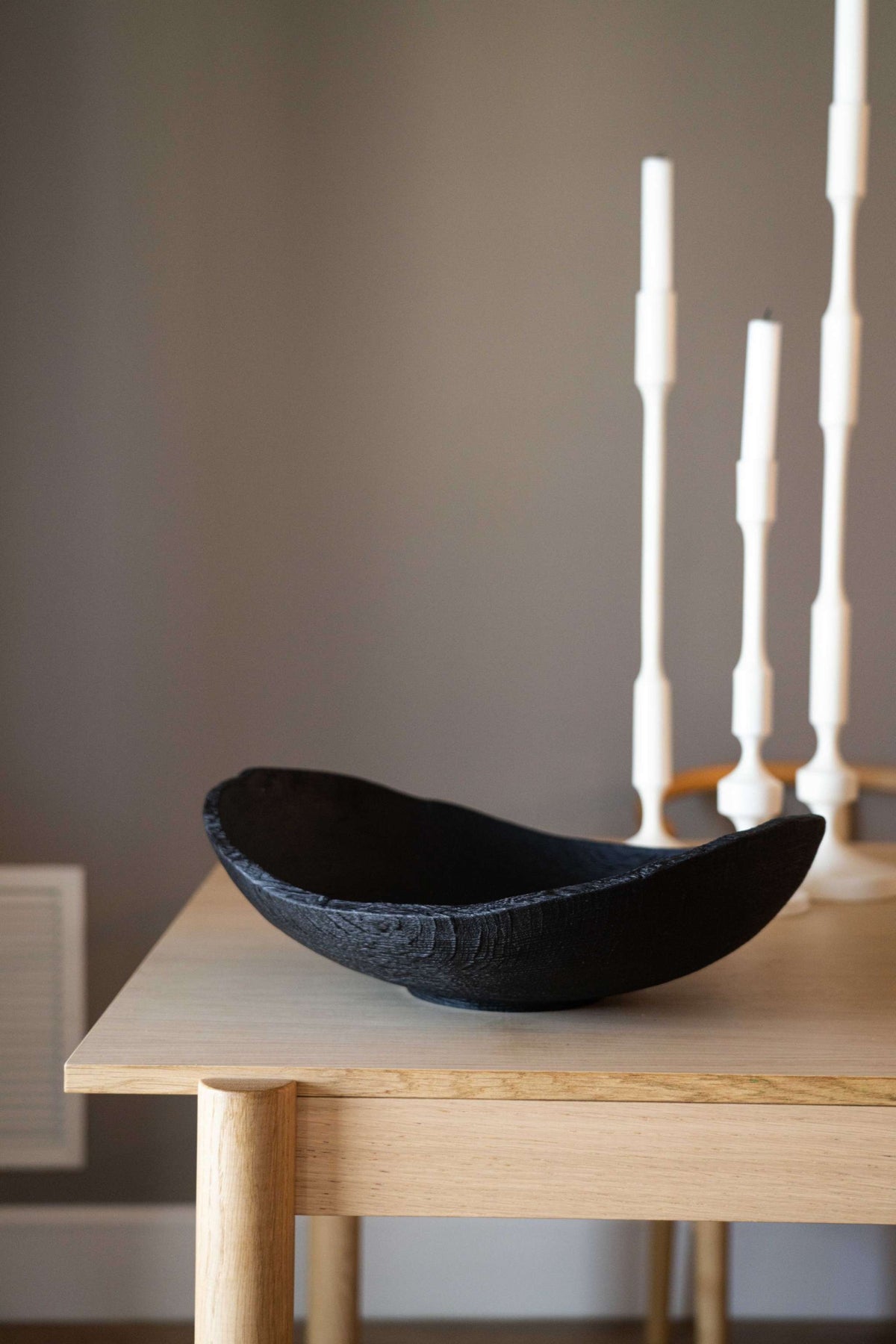 Hand-carved large charred wood shallow bowl made from ash wood with a natural black finish and rustic ripped edges