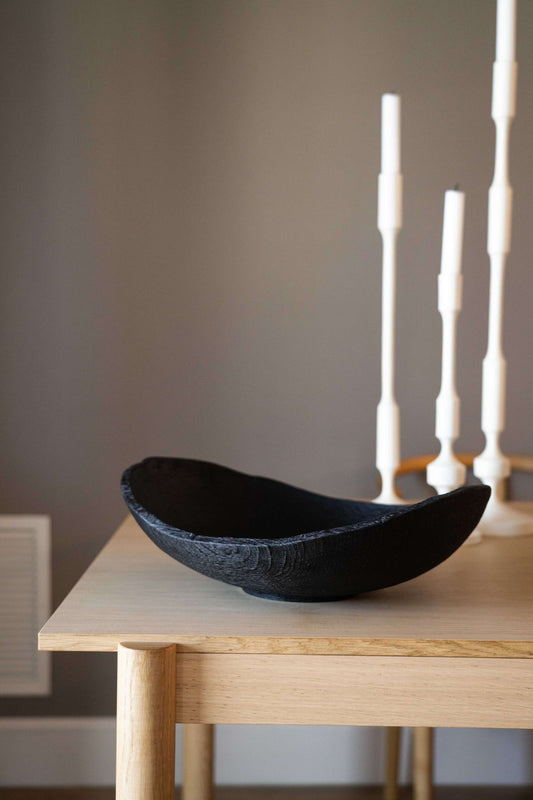 Hand-carved large charred wood shallow bowl made from ash wood with a natural black finish and rustic ripped edges
