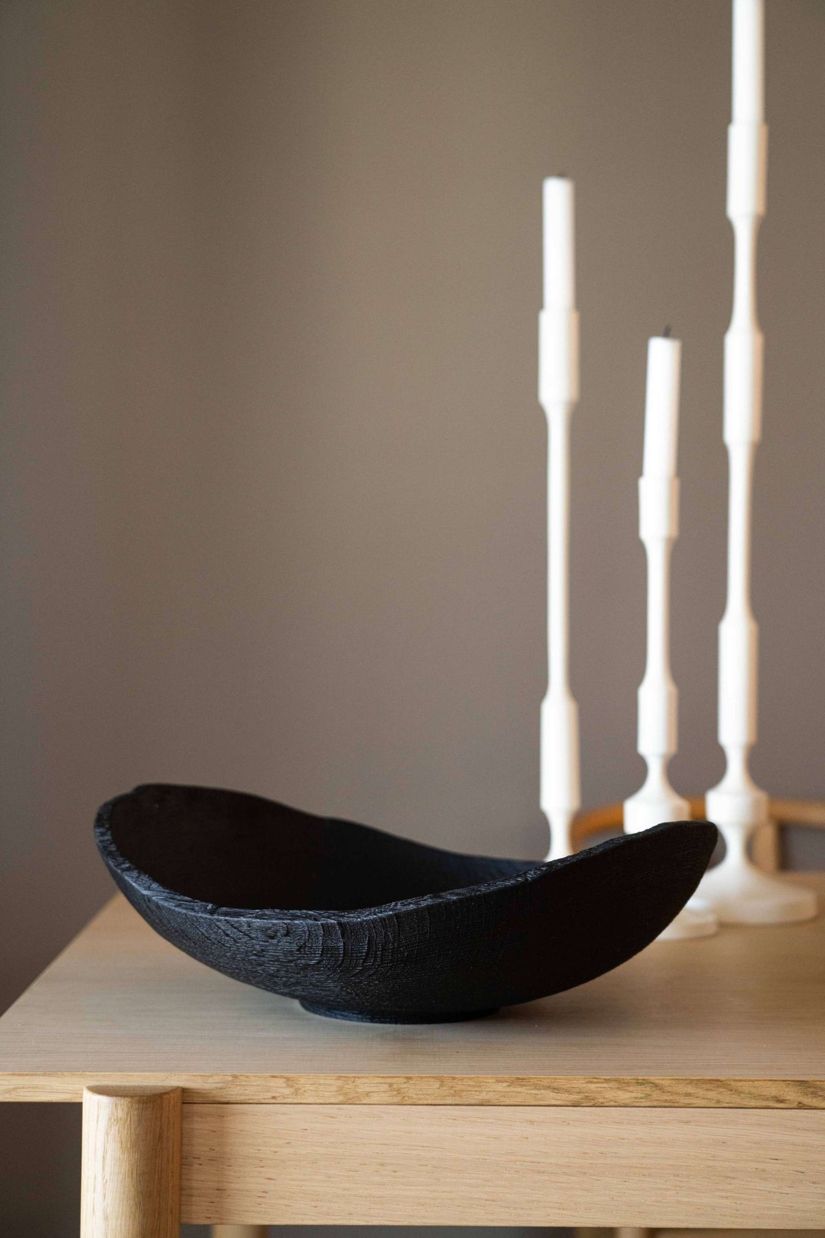 Hand-carved large charred wood shallow bowl with natural ash wood texture and rustic ripped edges