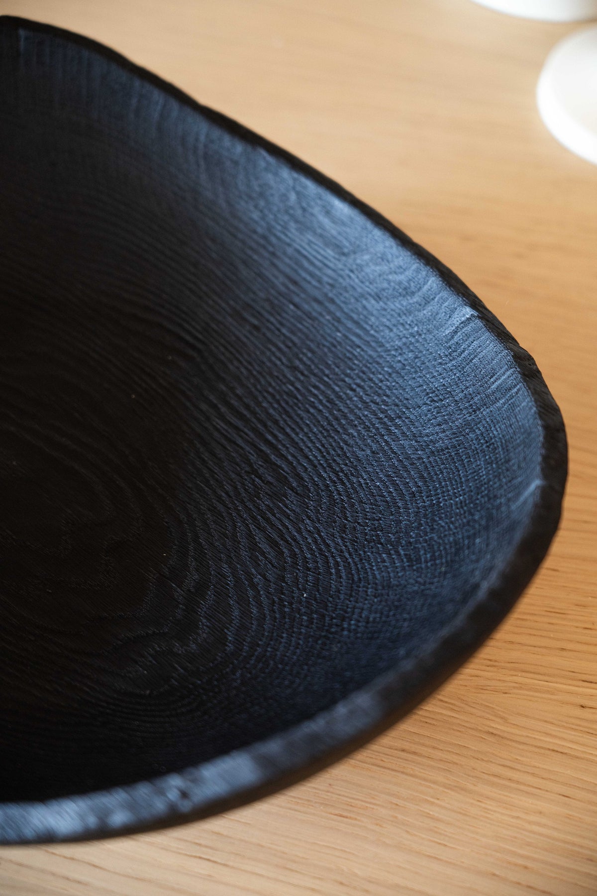 Hand-carved large charred wood shallow bowl made from ash wood with a rustic wabi-sabi design
