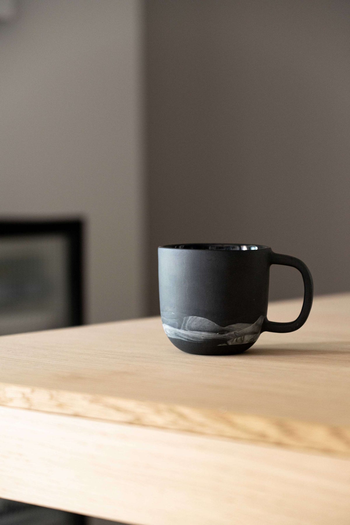 Handmade porcelain coffee mug with white swirls, black color, food-safe glaze, and dishwasher safe from Ukraine studio
