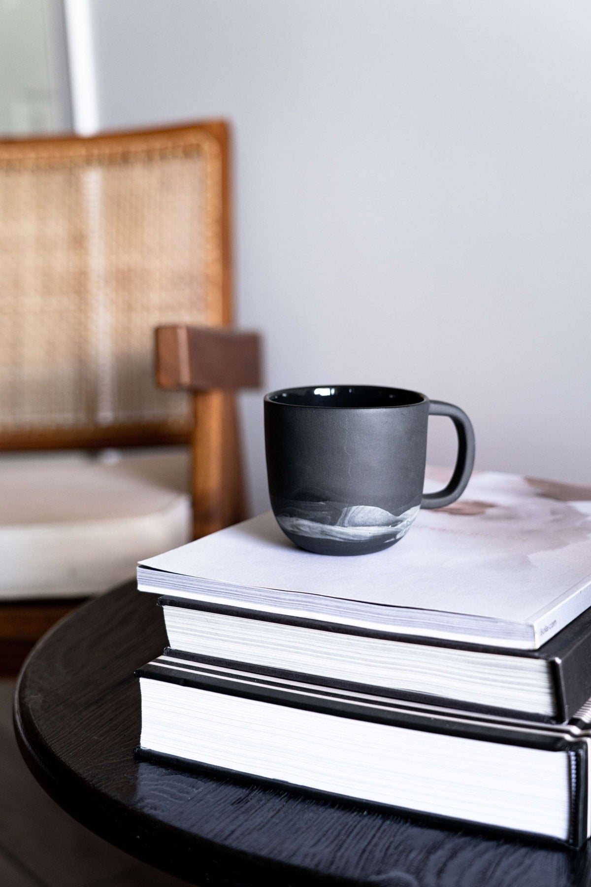 Handmade porcelain coffee mug with white clay swirls inspired by Iceland, black exterior, food-safe glaze, dishwasher and microwave safe, crafted in Ukraine