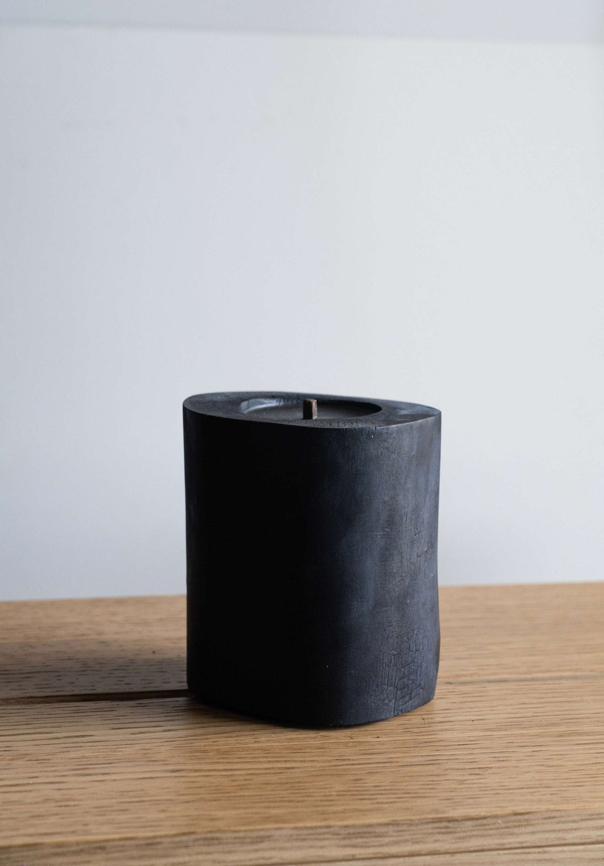 Black Illusions Wood Candle made of charred polished wood with multi-layer wick and natural beeswax coating