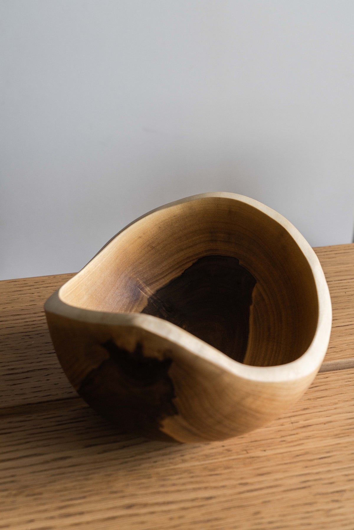 Hand carved small wooden walnut bowl with natural wood grain and oil finish